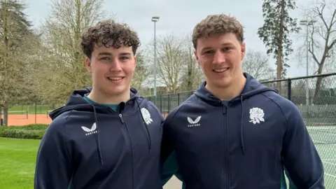 Declan Treacey (left) stands with his arm around brother Connor (right)