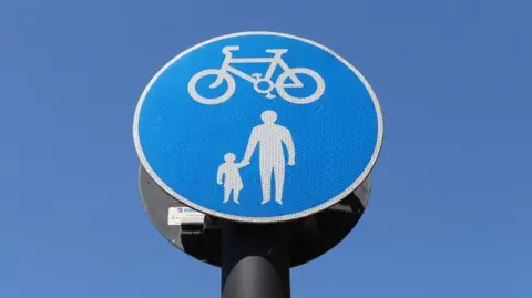 A pedestrian and cyclist sign