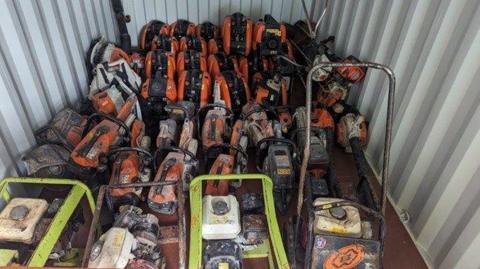 A range of tools in what looks like a shipping container