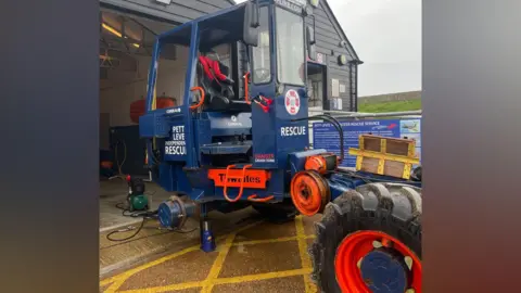 Pett Level Independent Rescue Boat A blue launch vehicle stationed at a lifeboat station.