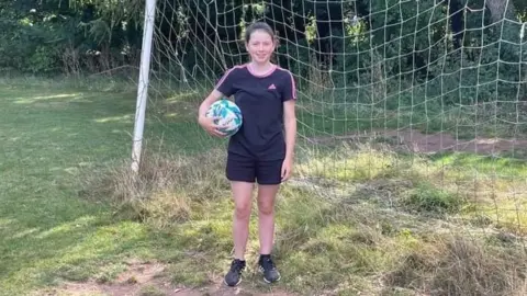 Julie Lacey with a football