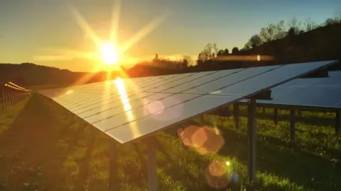 Getty Images The sun shining on a solar panel