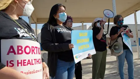 Reuters Protesters stand outside the Starr County Jail over abortion charge