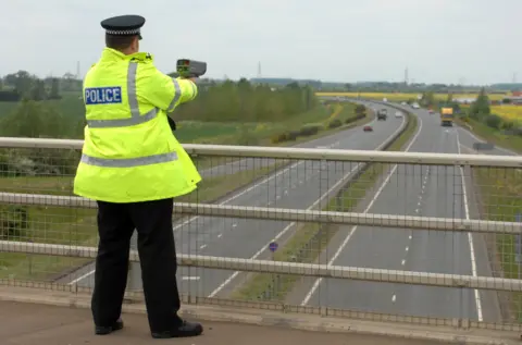 Getty Images Police officer with speed gun