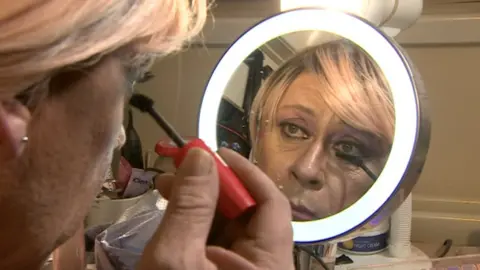 Ms Halliley putting on make-up