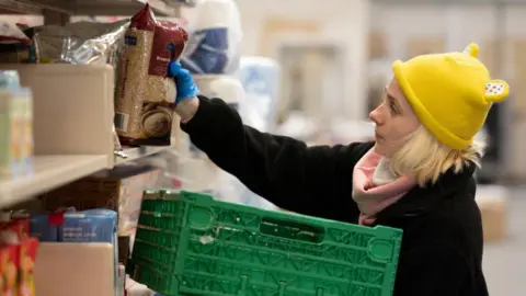 Getty Images Woman preparing a food parcel