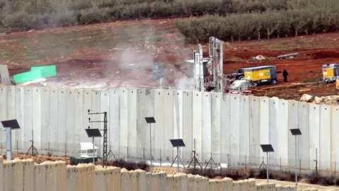 AFP A view of Israeli machinery operating behind the border wall in Israel on 4 December