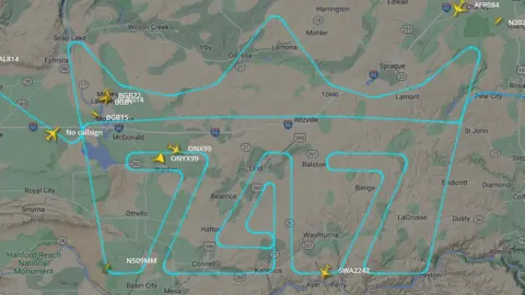 Courtesy of www.flightradar24.com Image showing flight path of last 747 plane. Path depicts a crown with the numbers 747 displayed.