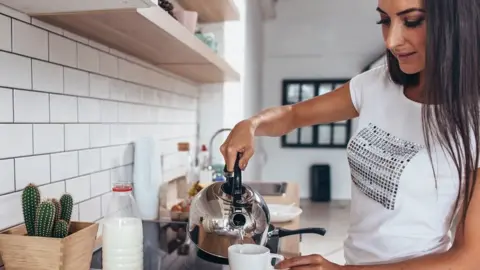 Getty Images A woman making a cup of tea