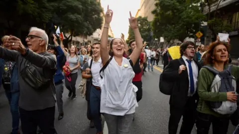 Reuters A woman dances during protests against university cuts in Buenos Aires.