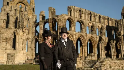 OLI SCARFF/Getty Images Participants stood in front of Whitby Abbey
