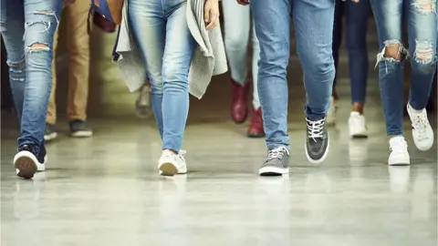 Getty Images Students walk in corridor