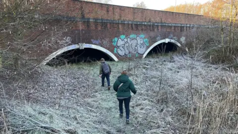 Richard and Harriet walking towards the bridge