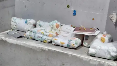 City of London Police Cash was found wrapped in nappies and stashed in a wall