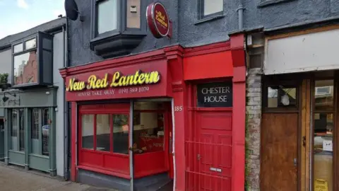Google The entrance of New Red Lantern in Chester-le-Street. The takeaway front is red. New Red Lantern is written in yellow above the windows. 