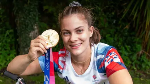 PA Media Beth Shriever sat on her BMX and held up her gold medal