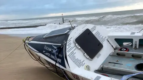 A corner of the large rowing boat with branding written on it saying Talisker Whisky Atlantic Challenge