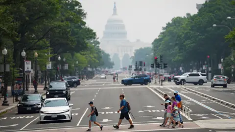 Reuters Pedestrians cross Pennsylvania Avenue with the US Capitol in the background