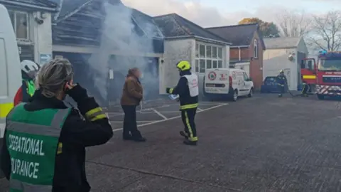 Devon and Cornwall Police Several firefighters and other people involved in a fire safety training exercise.