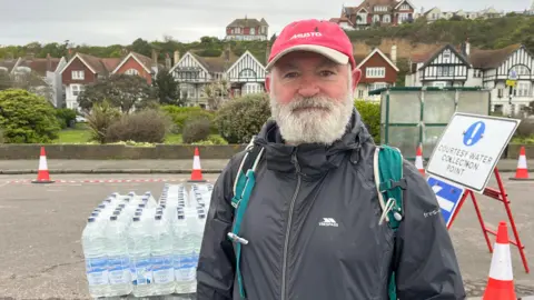 BBC/Sam Dixon-French David Sparks collecting water in Hastings 