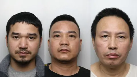 Police mugshots of three men, placed side by side. They all have black hair and are staring into the camera.