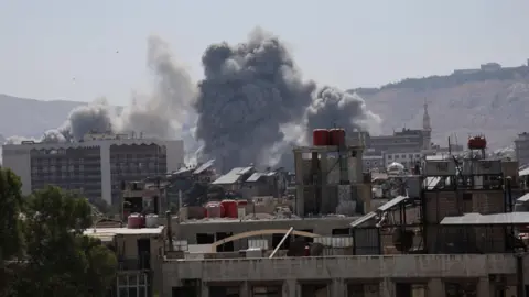 Smoke rises after an Israeli strike on Syria's defence ministry headquarters in Damascus, Syria (16 July 2025)