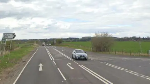 Google The junction of the A76 and B713 between Catrine and Auchinleck with the smaller road on the right. A car passes and heads towards us.