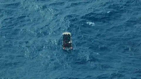 A birds-eye view of migrants in a boat in the Central Mediterranean crossing
