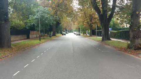 Pittville Circus Road in Cheltenham on an autumn day, lined with trees