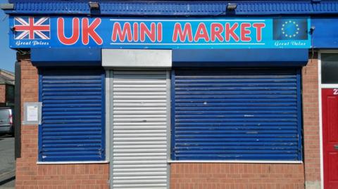 UK Mini Market in South Moor, with its blue shutters down.