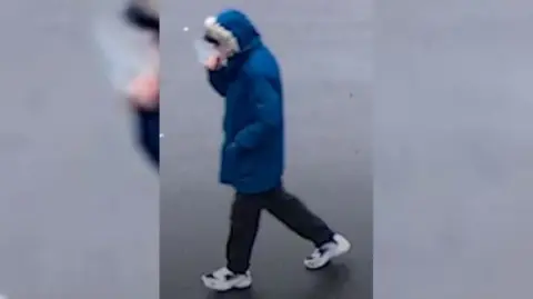 Greater Manchester Police Steven Caulfield wearing a blue parka style coat with his hood up