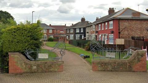 Street view of a row of houses with a path in front of them