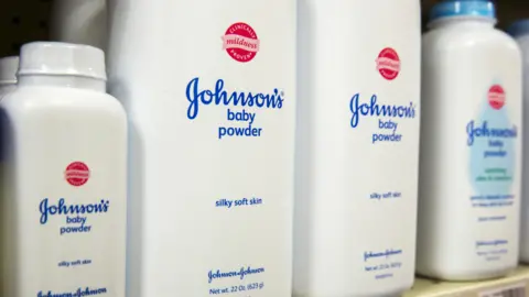 Bottles of Johnson's baby powder on a supermarket shelf