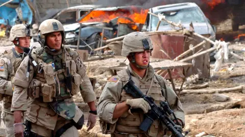 US Army via Getty Images US soldiers patrol Tal Afar on 11 October 2005 after a suicide bomb attack