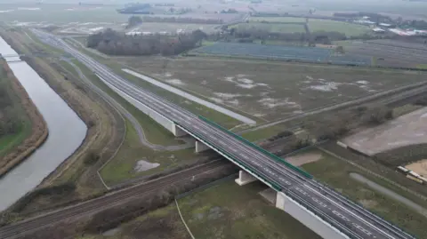 A drone picture of a new road and bridge, the road ends suddenly