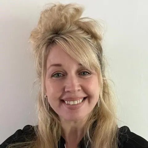 Scottish Socialist Party A woman with long blond hair, standing in front of a cream background, smiles at the camera