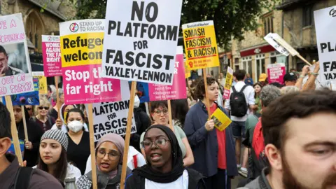 Protesters take part in a "All Out Against Tommy Robinson" protest organised by groups including Stand Up to Racism Oxford.