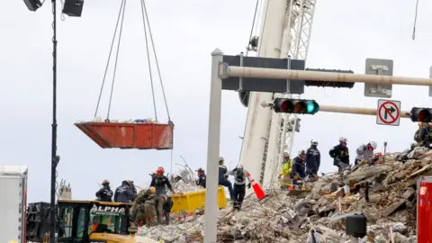 Reuters Search and Rescue teams look for possible survivors in the partially collapsed 12-story Champlain Tower