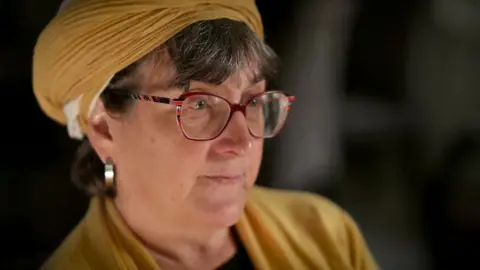 A headshot portrait of a female settler