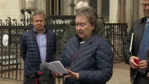 Lady reads statement outside court