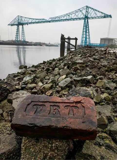 Chris Tilney Brick on the foreshore of the River Tees with the transporter bridge in the background