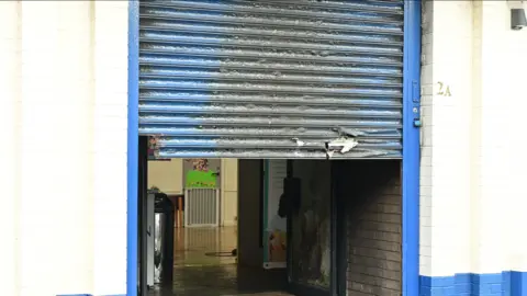 Pacemaker Damaged shutter of church in Templemore Street in east Belfast