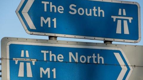 A sign of the M1 showing north and south 