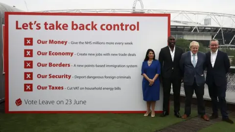 Carl Court Priti Patel, Boris Johnson, Michael Gove and footballer Sol Campbell with a Vote Leave poster in 2016