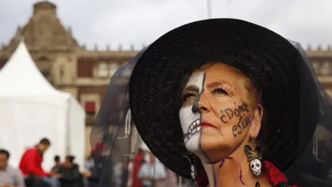 Getty Images A protester with face paint saying "Where are they?" in reference to the missing 43 Ayotzinapa students