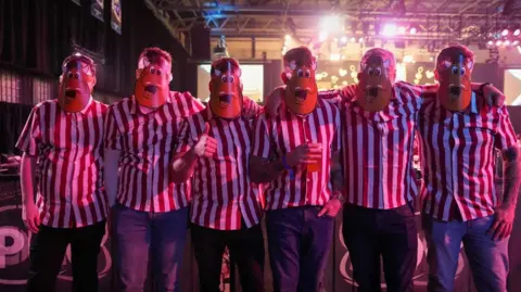 City of Wolverhampton Council Six people are wearing the same type of mask and a red and white striped top.