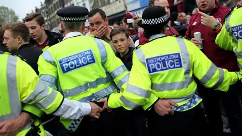 Getty Images Police try to control West Ham fans