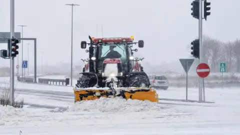 Reuters A snowplough clears snow from a road in Aalborg, Denmark
