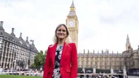 Labour MP Kim Leadbeater stands in front of the houses of parliament looking ahead of the vote on assisted dying.