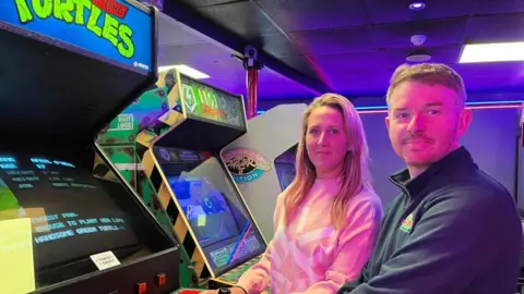 Andrew Turner/BBC Sophi Parkes and Dean Gray playing a retro video game